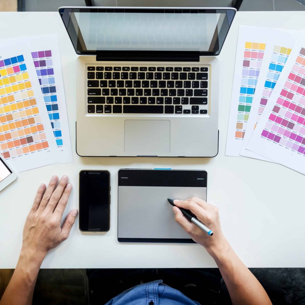 top-view-of-young-graphic-designer-working-on-desktop-computer-and-using-some-color-swatches-top-view.jpg top-view-of-young-graphic-designer-working-on-desktop-computer-and-using-some-color-swatches-top-view.jpg